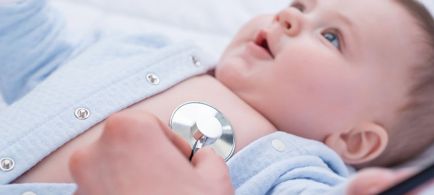 Pediatrician examining an infant